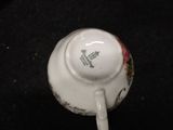 a white tea cup with a floral design on it