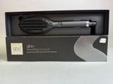 a hair brush in a box on a table
