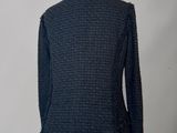 a black jacket with fray edges on a mannequin mannequin