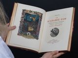 someone is holding a book with a picture of a cat on it