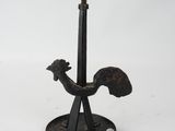 a black metal candle holder with a bird on it