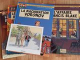 three books on a wooden table with a picture of a man and a woman