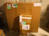 a stack of boxes sitting in a room next to a wall