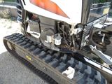 a close up of a tractor with a track on the ground