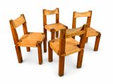 four wooden chairs sitting next to each other on a white surface