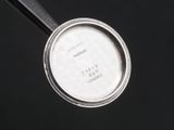 a metal pan with a lid on a black surface