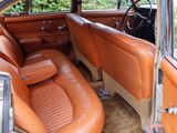an old car with leather seats in the back of it