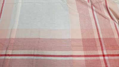 a red and white checkered bed spread on a bed