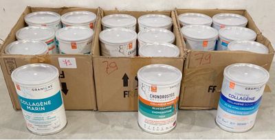 several cans of white paint sitting on top of a cardboard box