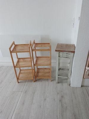 three wooden shelves in the corner of a room