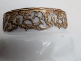 a close up of a gold ring on a white vase