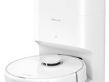 an image of a white robotic vacuum cleaner on a white surface