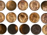a close up of a bunch of coins on a white surface