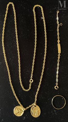 two gold necklaces and a ring on a black surface