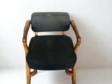 a black chair with a wooden frame and a black seat