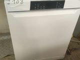 a white dishwasher sitting on a counter in a kitchen
