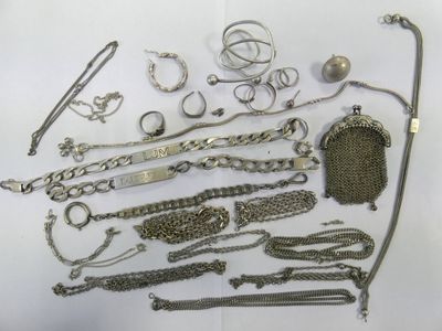 a lot of silver jewelry on a white surface