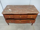 a marble top chest of drawers with brass pulls