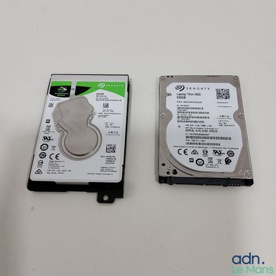 two hard drives sitting side by side on a table