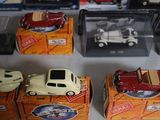 a lot of toy cars on display in a display case