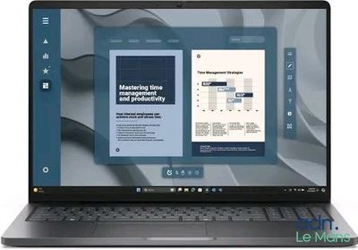 the laptop is open on a white background with a book on the screen