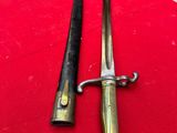 pair of antique brass - plated swords on a red cloth