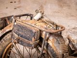 an old motorcycle that is sitting in the dirt