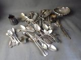 a lot of silver spoons and silverware on the table