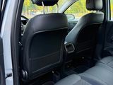 the back seats of a car with the door open in a parking lot