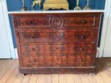 a dresser with a marble top in a room with blue walls