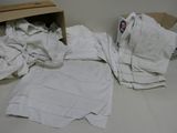 a pile of toilet paper on the floor next to a chair