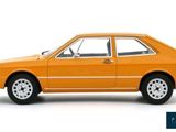 an orange model of a small car on a white background