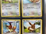 four pokemon cards are on display in a store for sale