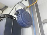 a blue trash can and a black trash can in a garage