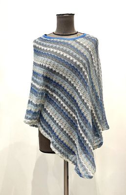 blue and white striped ponchy on a mannequin stand