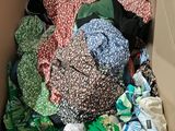 a cardboard box filled with clothes and other items