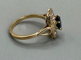 an image of a gold ring with a black and white diamond