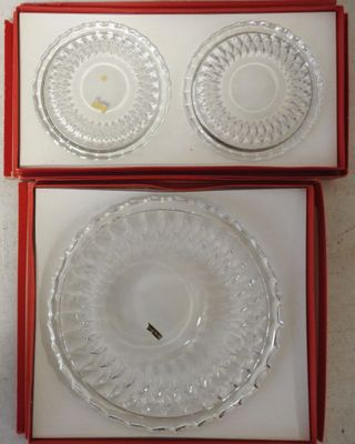 two clear glass plates in a red box on a white surface