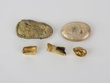 a close up of a rock and some other items on a white surface