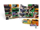 many different types of cameras in a pile together