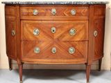 an image of a wooden dresser with marble top in a room