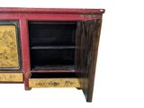 a red cabinet with a painting on the door