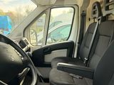 the interior of a van with black seats and a steering wheel