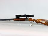 a rifle with a scope mounted on it sitting on a table
