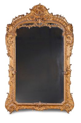 an ornately carved mirror with a black background and a gold frame