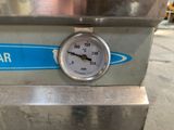 a close up of a gauge on the side of a machine