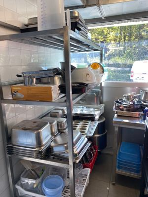 a kitchen with a lot of pots and pans on the shelves