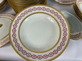 many plates and bowls on a table with a spoon