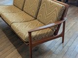 a couch that is sitting on a hard wood floor