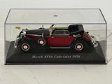 a red and black model of a car in a glass case